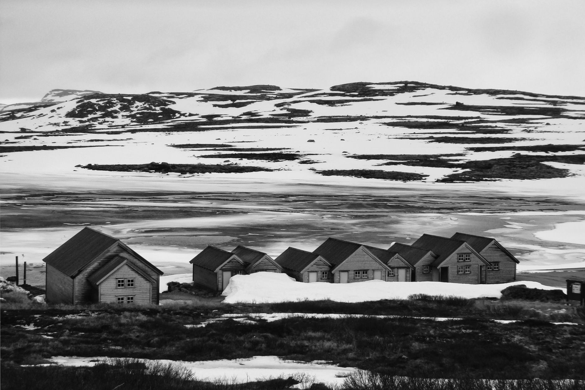 Minimalist Nordic timber cabin perched over calm water